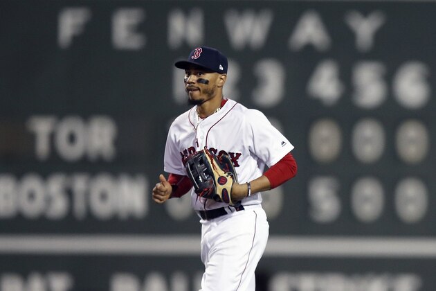 Boston Red Sox's Mookie Betts comes in past the scoreboard after the Red Sox defeated the Toronto Blue Jays during a baseball game in Boston, Thursday, July 12, 2018. (AP Photo/Michael Dwyer)