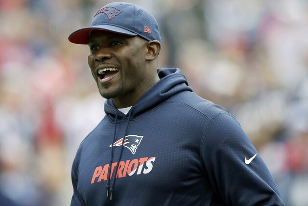 FILE - In this Sept. 9, 2018, file photo, New England Patriots linebackers coach Brian Flores watches his team warm up before an NFL football game against the Houston Texans in Foxborough, Mass. Flores met Saturday, Jan. 5, 2019, with Cleveland Browns general manager John Dorsey about the team's head coach opening. He’s the fifth candidate to meet with Dorsey. (AP Photo/Charles Krupa, File)