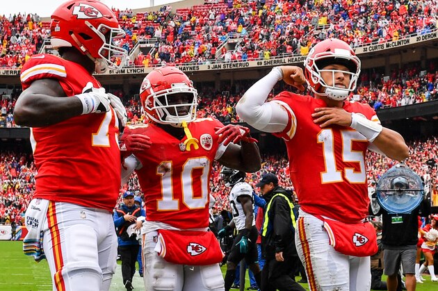 KANSAS CITY, MO - OCTOBER 7: Patrick Mahomes #15 of the Kansas City Chiefs flexes his muscle with teammates Tyreek Hill #10 and Cameron Erving #75 after scoring a rushing touchdown during the first quarter of the game against the Jacksonville Jaguars at Arrowhead Stadium on October 7, 2018 in Kansas City, Missouri. (Photo by Peter Aiken/Getty Images)