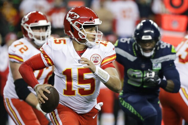 Kansas City Chiefs quarterback Patrick Mahomes (15) looks to pass against the Seattle Seahawks during the first half of an NFL football game, Sunday, Dec. 23, 2018, in Seattle. (AP Photo/Elaine Thompson)