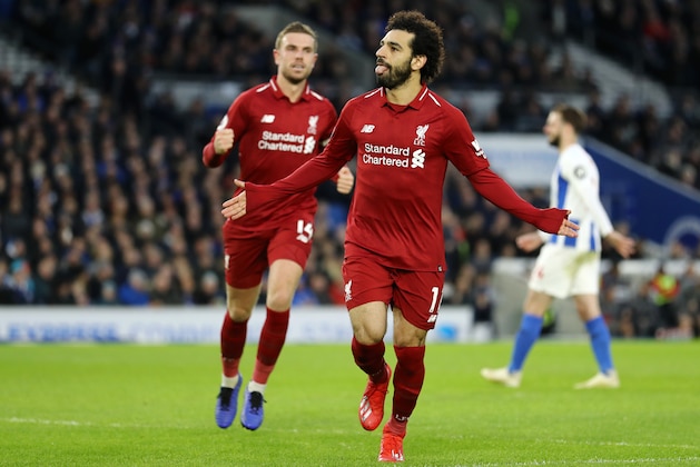 BRIGHTON, ENGLAND - JANUARY 12:  Mohamed Salah of Liverpool celebrates with team mate Jordan Henderason of Liverpool after scoring their first goal from the penalty spot during the Premier League match between Brighton & Hove Albion and Liverpool FC at American Express Community Stadium on January 12, 2019 in Brighton, United Kingdom.  (Photo by Bryn Lennon/Getty Images)