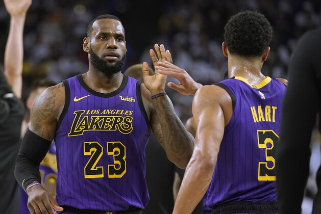 Los Angeles Lakers forward LeBron James (23) high-fives Josh Hart (3) at the end of the first half of the team's NBA basketball game against the Golden State Warriors on Tuesday, Dec. 25, 2018, in Oakland, Calif. (AP Photo/Tony Avelar)