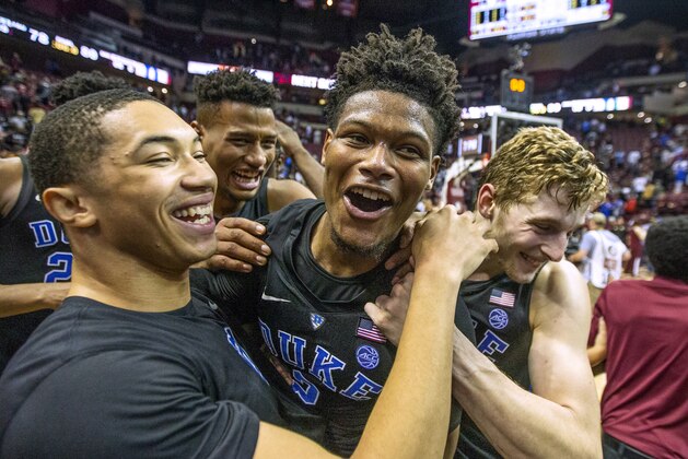 Duke guard Jordan Goldwire, left, and forward Jack White, right, celebrate with Cam Reddish after Reddish scored the game-winning jump shot against Florida State with less than a second left in the second half of an NCAA college basketball game in Tallahassee, Fla., Saturday, Jan. 12, 2019. Duke defeated Florida State 80-78. (AP Photo/Mark Wallheiser)