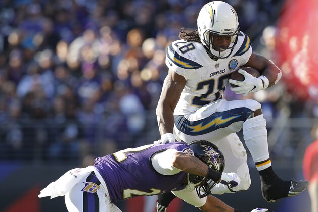 Los Angeles Chargers running back Melvin Gordon (28) leaps to avoid Baltimore Ravens cornerback Jimmy Smith (22) in the first half of an NFL wild card playoff football game, Sunday, Jan. 6, 2019, in Baltimore. (AP Photo/Carolyn Kaster)