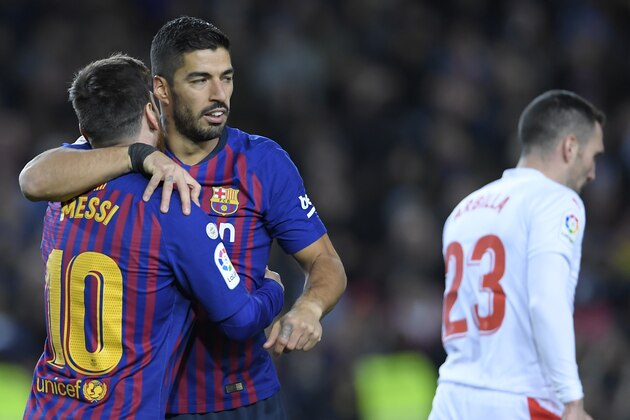 Barcelona's Argentinian forward Lionel Messi celebrates his goal with Barcelona's Uruguayan forward Luis Suarez (2L) during the Spanish League football match between FC Barcelona and SD Eibar at the Camp Nou stadium in Barcelona on January 13, 2019. (Photo by LLUIS GENE / AFP)        (Photo credit should read LLUIS GENE/AFP/Getty Images)