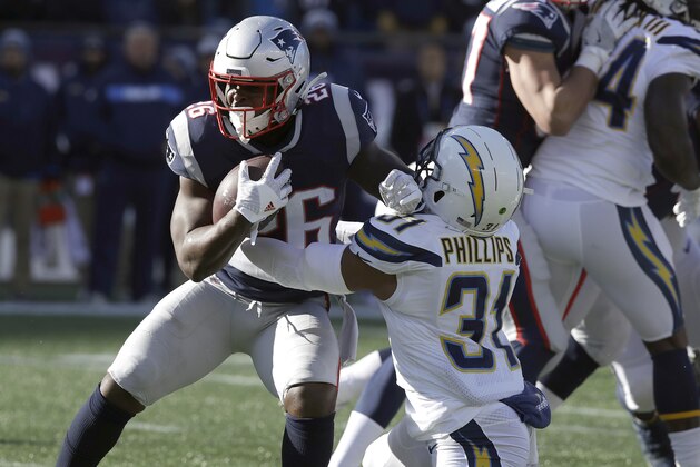 Los Angeles Chargers defensive back Adrian Phillips (31) tackles New England Patriots running back Sony Michel (26) during the first half of an NFL divisional playoff football game, Sunday, Jan. 13, 2019, in Foxborough, Mass. (AP Photo/Charles Krupa)