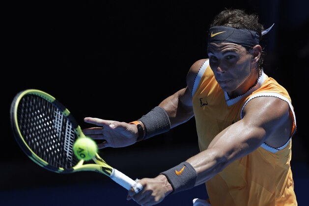 Spain's Rafael Nadal makes a backhand return in his first round match against Australia's James Duckworth at the Australian Open tennis championships in Melbourne, Australia, Monday, Jan. 14, 2019. (AP Photo/Aaron Favila) Spain's Rafael Nadal makes a backhand return in his first round match against Australia's James Duckworth at the Australian Open tennis championships in Melbourne, Australia, Monday, Jan. 14, 2019. (AP Photo/Aaron Favila)