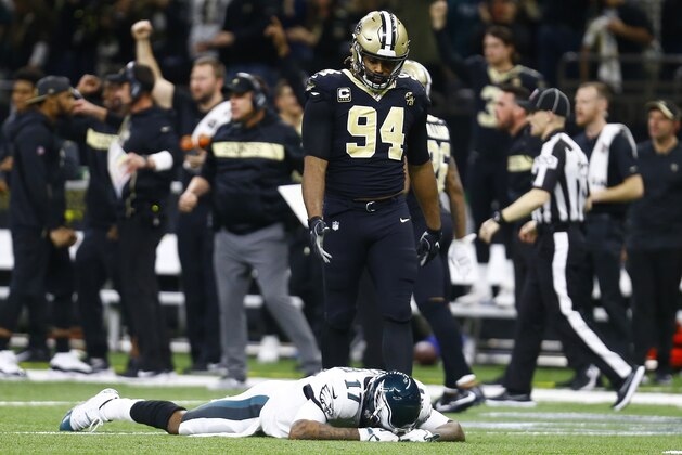 Philadelphia Eagles wide receiver Alshon Jeffery (17) lies on the turf in front of New Orleans Saints defensive end Cameron Jordan (94) after the Saints intercepted a pass in the second half of an NFL divisional playoff football game in New Orleans, Sunday, Jan. 13, 2019. The Saints won 20-14. (AP Photo/Butch Dill)