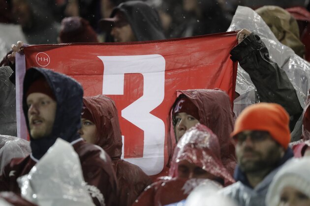 Fans hold up a #3 flag in honor of former Washington State quarterback Tyler Hilinski, who committed suicide in January of 2018, during the first half of an NCAA college football game between Washington and Washington State, Friday, Nov. 23, 2018, in Pullman, Wash. (AP Photo/Ted S. Warren)