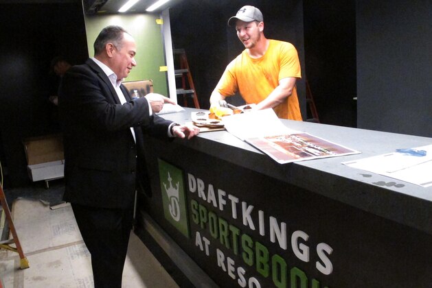 In this Nov. 13, 2018 photo, Mark Giannantonio, president of Resorts Casino in Atlantic City N.J., speaks with a worker about progress on the casino's new sports betting facility it will open with DraftKings on Nov. 20. The facility is the latest in a race among New Jersey casinos, racetracks and bookmakers to have not only an online operation but also a physical facility to attract gamblers in New Jersey's fast-growing sports betting market. (AP Photo/Wayne Parry) In this Nov. 13, 2018 photo, Mark Giannantonio, president of Resorts Casino in Atlantic City N.J., speaks with a worker about progress on the casino's new sports betting facility it will open with DraftKings on Nov. 20. The facility is the latest in a race among New Jersey casinos, racetracks and bookmakers to have not only an online operation but also a physical facility to attract gamblers in New Jersey's fast-growing sports betting market. (AP Photo/Wayne Parry)