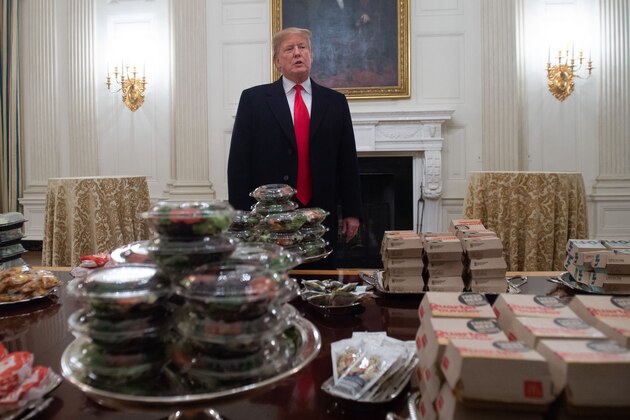 US President Donald Trump speaks alongside fast food he purchased for a ceremony honoring the 2018 College Football Playoff National Champion Clemson Tigers in the State Dining Room of the White House in Washington, DC, January 14, 2019. - Trump says the White House chefs are furloughed due to the partial government shutdown. (Photo by SAUL LOEB / AFP)        (Photo credit should read SAUL LOEB/AFP/Getty Images)