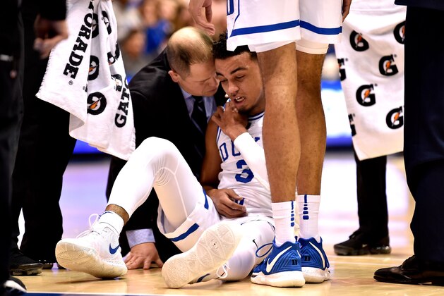 DURHAM, NORTH CAROLINA - JANUARY 14: A trainer tends to Tre Jones #3 of the Duke Blue Devils after a collision on the floor during the first half of their game against the Syracuse Orange at Cameron Indoor Stadium on January 14, 2019 in Durham, North Carolina. (Photo by Grant Halverson/Getty Images)