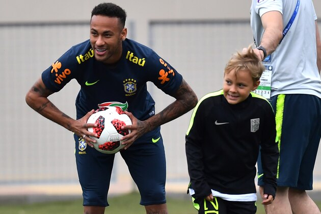 Brazil's forward Neymar (L) smiles past his son Davi Lucca during a training session at Yug Sport Stadium, in Sochi, on July 4, 2018, during the Russia 2018 World Cup football tournament. (Photo by NELSON ALMEIDA / AFP)        (Photo credit should read NELSON ALMEIDA/AFP/Getty Images)