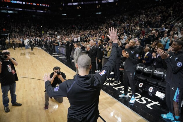 Charlotte Hornets' Tony Parker waves to fans cheering for him before an NBA basketball game against the San Antonio Spurs, Monday, Jan. 14, 2019, in San Antonio. Charlotte won 108-93. Parker played for San Antonio from 2001 to 2018, winning four NBA Championships. This was Parker's first visit back to San Antonio after signing with Charlotte. (AP Photo/Darren Abate)