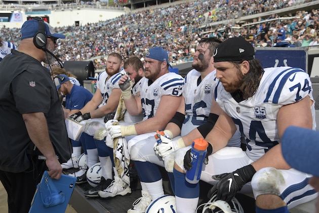 Indianapolis Colts offensive line coach Dave Deguglielmo, left, talks to the offensive linemen on the bench during the second half of an NFL football game against the Jacksonville Jaguars Sunday, Dec. 2, 2018, in Jacksonville, Fla. (AP Photo/Phelan M. Ebenhack)