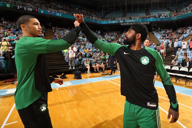 CHAPEL HILL, NC - SEPTEMBER 28:  Jayson Tatum #0 and Kyrie Irving #11 of the Boston Celtics exchange a high five against the Charlotte Hornets during a pre-season game on September 28, 2018 at Dean E. Smith Center in Chapel Hill, North Carolina. NOTE TO USER: User expressly acknowledges and agrees that, by downloading and or using this photograph, User is consenting to the terms and conditions of the Getty Images License Agreement.  Mandatory Copyright Notice:  Copyright 2018 NBAE (Photo by Kent Smith/NBAE via Getty Images)