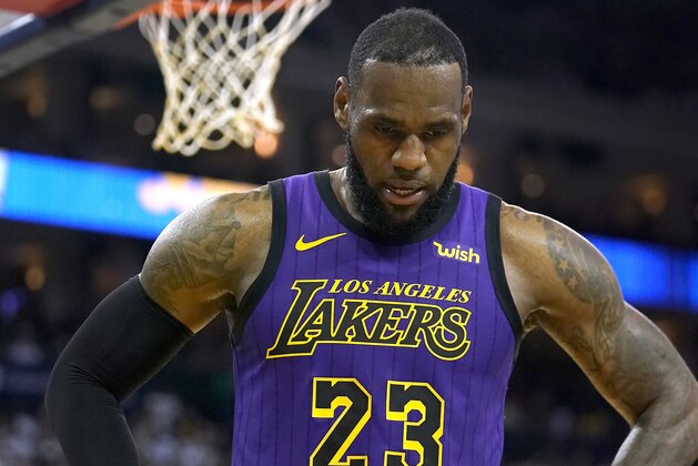Los Angeles Lakers forward LeBron James walks off the court after straining his left groin during the second half of the team's NBA basketball game against the Golden State Warriors on Tuesday, Dec. 25, 2018, in Oakland, Calif. James left the game, which the Lakers won 127-101. (AP Photo/Tony Avelar)