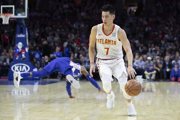 Atlanta Hawks' Jeremy Lin, right, in action as Philadelphia 76ers' Robert Covington, left, goes flying back during the first half of an NBA basketball game, Monday, Oct. 29, 2018, in Philadelphia. The 76ers won 113-92. (AP Photo/Chris Szagola)
