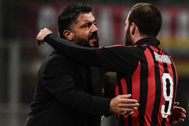AC Milan's Argentine forward Gonzalo Higuain (R) celebrates with AC Milan's Italian coach Gennaro Gattuso after scoring 2-1 during the Italian Serie A football match AC Milan vs Spal on December 29, 2018 at San Siro stadium in Milan. (Photo by Marco BERTORELLO / AFP)        (Photo credit should read MARCO BERTORELLO/AFP/Getty Images)