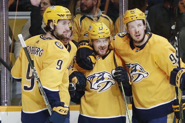 Nashville Predators left wing Viktor Arvidsson (33), of Sweden, celebrates with Filip Forsberg (9), of Sweden, and Ryan Johansen (92) after Arvidsson scored his third goal of the night against the Washington Capitals, during the second period of an NHL hockey game Tuesday, Jan. 15, 2019, in Nashville, Tenn. (AP Photo/Mark Humphrey)