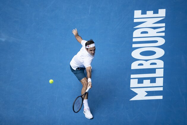 MELBOURNE, AUSTRALIA - JANUARY 16: Roger Federer of Switzerland play a backhand his second round match against Daniel Evans of Great Britain during day three of the 2019 Australian Open at Melbourne Park on January 16, 2019 in Melbourne, Australia. (Photo by Fred Lee/Getty Images)