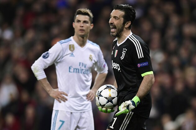 Juventus' Italian goalkeeper Gianluigi Buffon (R) reacts next to Real Madrid's Portuguese forward Cristiano Ronaldo during the UEFA Champions League quarter-final second leg football match between Real Madrid CF and Juventus FC at the Santiago Bernabeu stadium in Madrid on April 11, 2018. / AFP PHOTO / JAVIER SORIANO        (Photo credit should read JAVIER SORIANO/AFP/Getty Images)