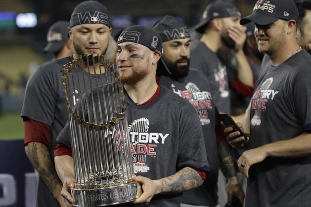 Boston Red Sox catcher Christian Vazquez holds the championship trophy after Game 5 of baseball's World Series against the Los Angeles Dodgers on Sunday, Oct. 28, 2018, in Los Angeles. The Red Sox won 5-1 to win the series 4 game to 1. (AP Photo/David J. Phillip)