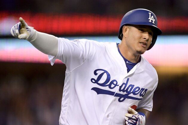 Los Angeles Dodgers' Manny Machado celebrates his two-run home run against the Atlanta Braves during the first inning of Game 2 of a baseball National League Division Series on Friday, Oct. 5, 2018, in Los Angeles. (AP Photo/Mark J. Terrill)