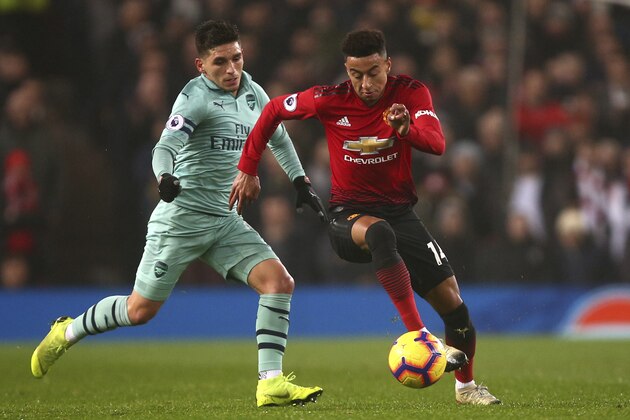 ManU midfielder Jesse Lingard, right, and Arsenal's Lucas Torreira, left, vie for the ball during the English Premier League soccer match between Manchester United and Arsenal at Old Trafford stadium in Manchester, England, Wednesday Dec. 5, 2018. (AP Photo/Dave Thompson)