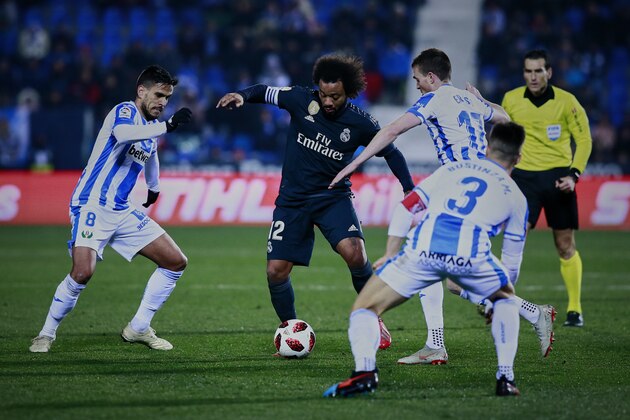 LEGANES, SPAIN - JANUARY 16: Marcelo (2ndL) of Real Madrid CF competes for the ball with Jose Luis edel Pozo alias Recio (L) and Javier Eraso (R) of Deportivo Leganes during the Copa del Rey Round of 16 second leg match between CD Leganes and Real Madrid at Estadio Municipal de Butarque on January 16, 2019 in Leganes, Spain. (Photo by Gonzalo Arroyo Moreno/Getty Images)