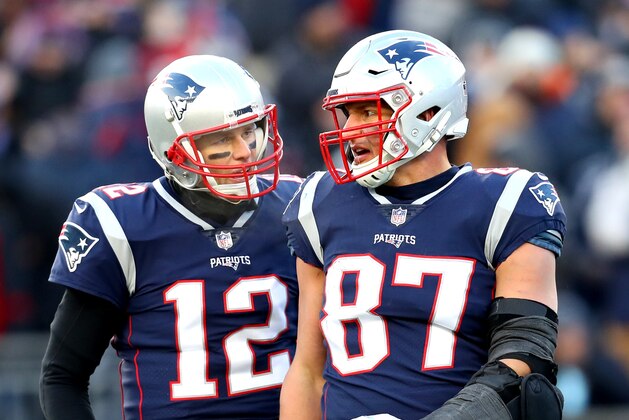 FOXBOROUGH, MASSACHUSETTS - JANUARY 13: Tom Brady #12 of the New England Patriots reacts with Rob Gronkowski #87 during the third quarter in the AFC Divisional Playoff Game against the Los Angeles Chargers at Gillette Stadium on January 13, 2019 in Foxborough, Massachusetts. (Photo by Maddie Meyer/Getty Images)