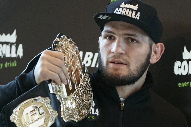 UFC lightweight champion Khabib Nurmagomedov holds the trophy belt during a news conference in Moscow, Russia, Monday, Nov. 26, 2018. The Russian professional mixed martial arts fighter Nurmagomedov, said he can imagine a reconciliation with Conor McGregor after the bitter feud around last month's title fight, but said he would like to fight Floyd Mayweather Jr. (AP Photo/Pavel Golovkin)