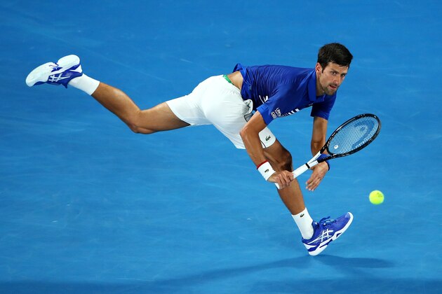MELBOURNE, AUSTRALIA - JANUARY 17: Novak Djokovic of Serbia plays a backhand during his second round match against Jo-Wilfried Tsonga of France during day four of the 2019 Australian Open at Melbourne Park on January 17, 2019 in Melbourne, Australia. (Photo by Cameron Spencer/Getty Images)