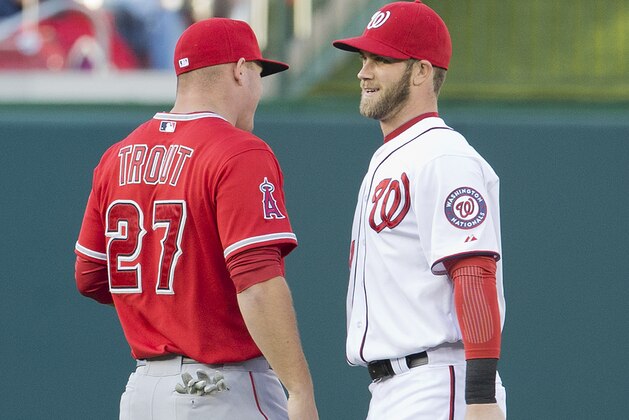 Los Angeles Angels Mike Trout, left, and Washington Nationals Bryce Harper, right, talk to each other during warm ups before the start of their baseball game, Wednesday, April 23, 2014 in Washington. (AP Photo/Pablo Martinez Monsivais)