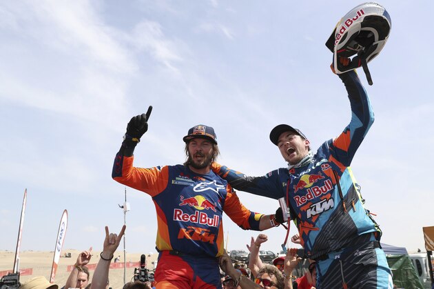 Toby Price of Australia, who took first on his KTM motorbike, left, celebrates with Matthias Walkner of Austria who took second on his KTM motorbike, after their arrival in the last stage of the Dakar Rally in Pisco, Peru, Thursday, Jan. 17, 2019. (AP Photo/Ricardo Mazalan)
