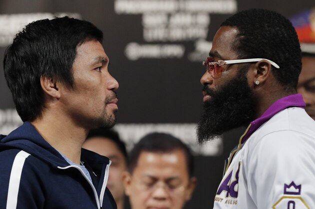 Manny Pacquiao, left, and Adrien Broner pose for photographers during a news conference Wednesday, Jan. 16, 2019, in Las Vegas. The two are scheduled to fight in a welterweight championship bout on Saturday. (AP Photo/John Locher)