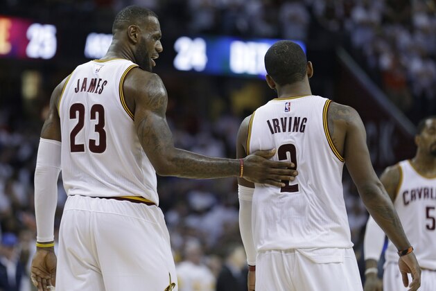 Cleveland Cavaliers' LeBron James (23) talks with Kyrie Irving (2) in the second half in Game 1 of a first-round NBA basketball playoff series against the Detroit Pistons, Sunday, April 17, 2016, in Cleveland. The Cavaliers won 106-101. (AP Photo/Tony Dejak)