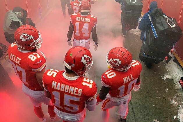 KANSAS CITY, MISSOURI - JANUARY 12:  Patrick Mahomes #15, Travis Kelce #87, and Tyreek Hill #10 of the Kansas City Chiefs exit the tunnel onto the field during player introductions prior to the AFC Divisional round playoff game against the Indianapolis Colts at Arrowhead Stadium on January 12, 2019 in Kansas City, Missouri. (Photo by Jamie Squire/Getty Images)
