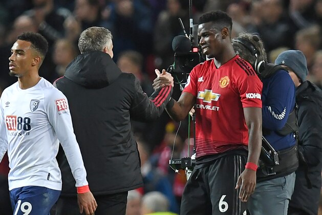 Manchester United's  Norwegian caretaker manager Ole Gunnar Solskjaer (2nd L) shakes hands with Manchester United's French midfielder Paul Pogba on the pitch after the English Premier League football match between Manchester United and Bournemouth at Old Trafford in Manchester, north west England, on December 30, 2018. - Manchester Utd won the game 4-1. (Photo by Paul ELLIS / AFP) / RESTRICTED TO EDITORIAL USE. No use with unauthorized audio, video, data, fixture lists, club/league logos or 'live' services. Online in-match use limited to 120 images. An additional 40 images may be used in extra time. No video emulation. Social media in-match use limited to 120 images. An additional 40 images may be used in extra time. No use in betting publications, games or single club/league/player publications. /         (Photo credit should read PAUL ELLIS/AFP/Getty Images)