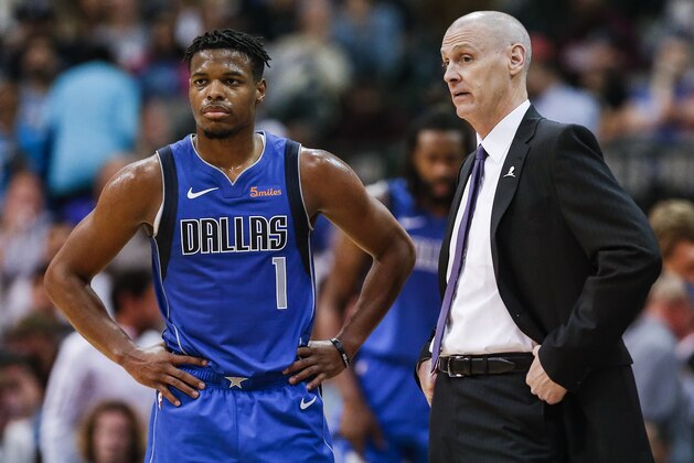 Dallas Mavericks guard Dennis Smith Jr. (1) and head coach Rick Carlisle look on during the second half of an NBA basketball game against the Washington Wizards, Tuesday, Nov. 6, 2018, in Dallas. Dallas won 119-100. (AP Photo/Brandon Wade)