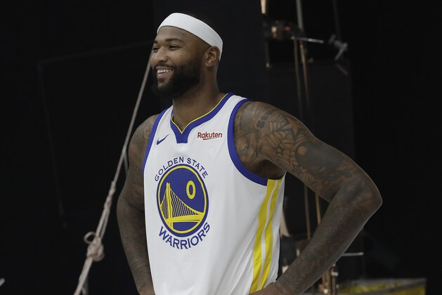 FILE - In this Sept. 24, 2018 file photo, Golden State Warriors' DeMarcus Cousins poses for photos during media day at the NBA basketball team's practice facility in Oakland, Calif. Cousins will start immediately for coach Steve Kerr when the All-Star center makes his long-awaited Warriors debut in about a week following his lengthy recovery from surgery on a torn left Achilles tendon. Cousins has targeted a game Jan. 18, 2019, at the Clippers as his return date and first game of the season, though Kerr said it could even be sooner if all continues going well.(AP Photo/Jeff Chiu, File)