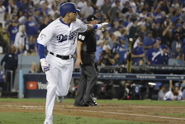 Los Angeles Dodgers' Manny Machado watches his single to deep left during the sixth inning in Game 3 of the World Series baseball game against the Boston Red Sox on Friday, Oct. 26, 2018, in Los Angeles. (AP Photo/David J. Phillip)