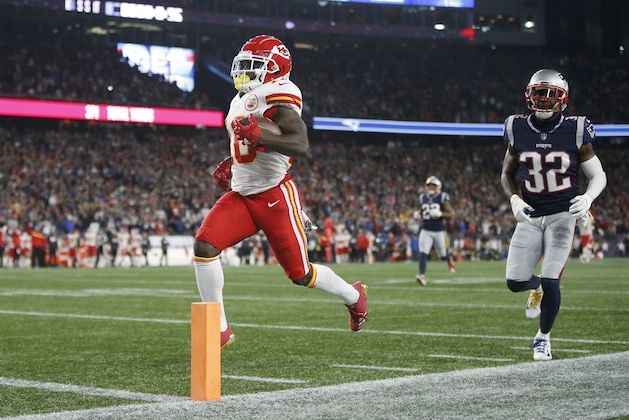 Kansas City Chiefs wide receiver Tyreek Hill (10) scores a touchdown in front of New England Patriots defensive back Devin McCourty (32) after catching a pass during the second half of an NFL football game, Sunday, Oct. 14, 2018, in Foxborough, Mass. (AP Photo/Michael Dwyer)