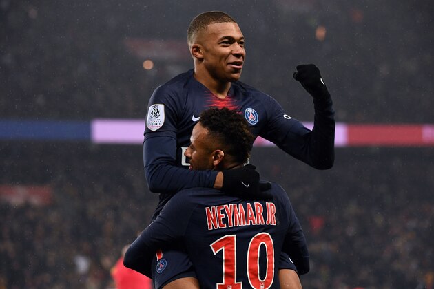Paris Saint-Germain's Brazilian forward Neymar (down) celebrates with Paris Saint-Germain's French forward Kylian Mbappe after scoring a goal during the French L1 football match Paris Saint-Germain (PSG) vs Guingamp (EAG), on January 19, 2019 at the Parc des Princes stadium in Paris. (Photo by Anne-Christine POUJOULAT / AFP)        (Photo credit should read ANNE-CHRISTINE POUJOULAT/AFP/Getty Images)