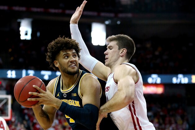 MADISON, WISCONSIN - JANUARY 19: Isaiah Livers #4 of the Michigan Wolverines handles the ball while being guarded by Ethan Happ #22 of the Wisconsin Badgers in the first half at the Kohl Center on January 19, 2019 in Madison, Wisconsin. (Photo by Dylan Buell/Getty Images) MADISON, WISCONSIN - JANUARY 19: Isaiah Livers #4 of the Michigan Wolverines handles the ball while being guarded by Ethan Happ #22 of the Wisconsin Badgers in the first half at the Kohl Center on January 19, 2019 in Madison, Wisconsin. (Photo by Dylan Buell/Getty Images)