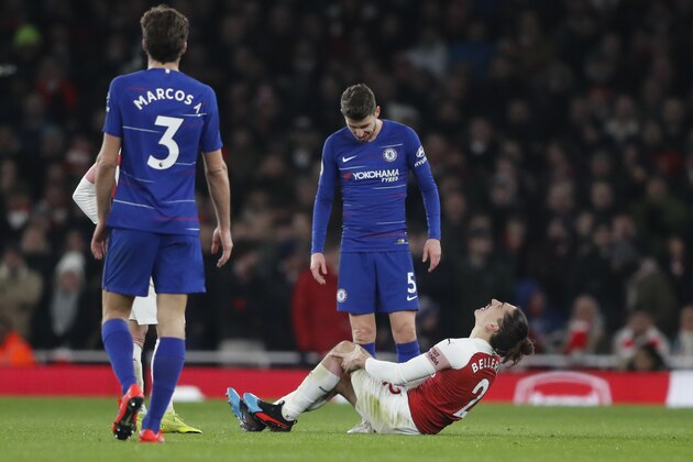 Chelsea's Jorginho looks down as Arsenal's Hector Bellerin goes down injured holding his knee during the English Premier League soccer match between Arsenal and Chelsea at the Emirates stadium in London, Saturday, Jan. 19, 2019. (AP Photo/Frank Augstein)
