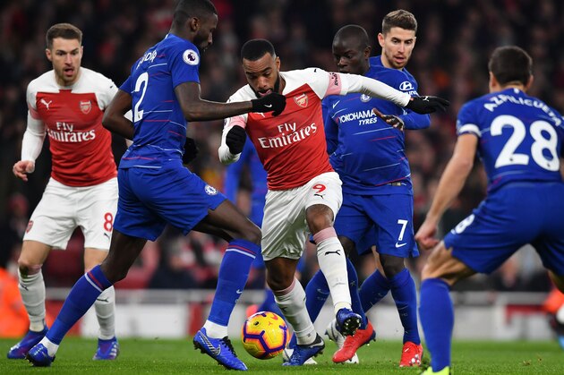 Arsenal's French striker Alexandre Lacazette (C) vies with Chelsea's German defender Antonio Rudiger (2nd L) and Chelsea's French midfielder N'Golo Kante (3rd R) during the English Premier League football match between Arsenal and Cheslea at the Emirates Stadium in London on January 19, 2019. (Photo by Ben STANSALL / AFP) / RESTRICTED TO EDITORIAL USE. No use with unauthorized audio, video, data, fixture lists, club/league logos or 'live' services. Online in-match use limited to 120 images. An additional 40 images may be used in extra time. No video emulation. Social media in-match use limited to 120 images. An additional 40 images may be used in extra time. No use in betting publications, games or single club/league/player publications. /         (Photo credit should read BEN STANSALL/AFP/Getty Images)