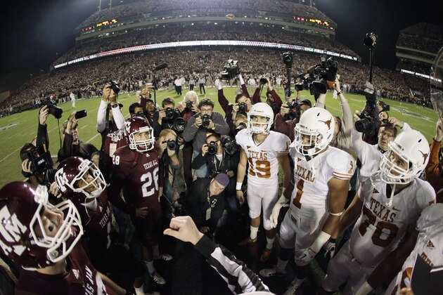 CORRECTS DATE OF PHOTO TO NOV. 24, 2011 - FILE - In this Nov. 24, 2011, file photo, an official tosses the coin in the air before the start of an NCAA college football game between Texas and Texas A&M in College Station, Texas. Texas state Rep. Lyle Larson on Tuesday, Nov. 27, 2018, filed a bill that would require his alma mater Texas A&M and Texas to resume their storied football rivalry during the Thanksgiving holiday period. The proposal would require an annual nonconference game on the fourth Thursday, Friday or Saturday of November. The teams last met Thanksgiving Day 2011 in College Station. (AP Photo/David J. Phillip, File)