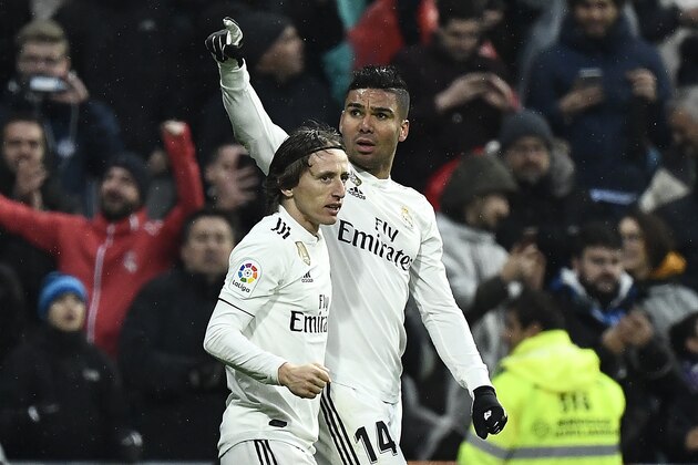 Real Madrid's Brazilian midfielder Casemiro (R) celebrates with Real Madrid's Croatian midfielder Luka Modric after scoring a goal during the Spanish League football match between Real Madrid and Sevilla at the Santiago Bernabeu stadium in Madrid on January 19, 2019. (Photo by PIERRE-PHILIPPE MARCOU / AFP)        (Photo credit should read PIERRE-PHILIPPE MARCOU/AFP/Getty Images)