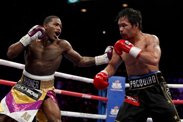 Adrien Broner, left, hits Manny Pacquiao during the WBA welterweight title boxing match Saturday, Jan. 19, 2019, in Las Vegas. (AP Photo/John Locher)